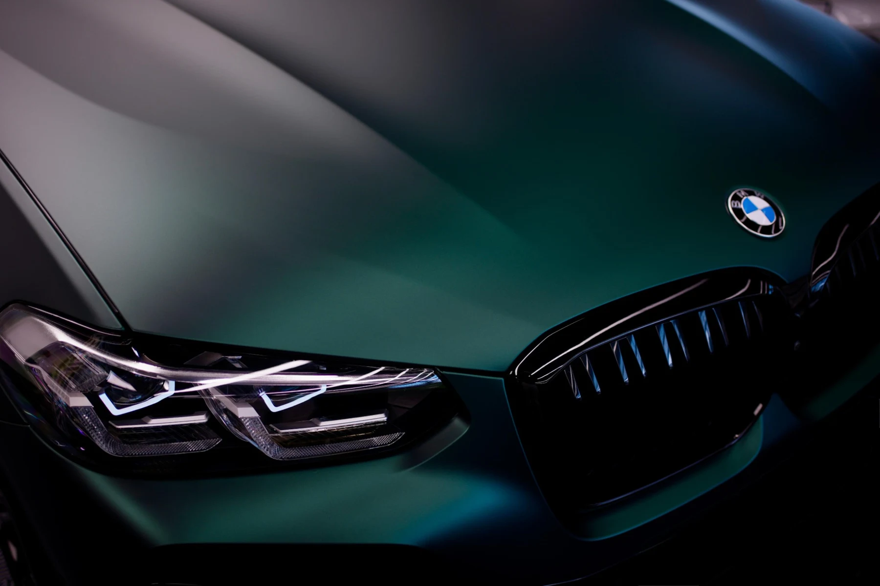 Close-up of a VZN-wrapped BMW showing its sculpted bonnet and colour-shifting finish